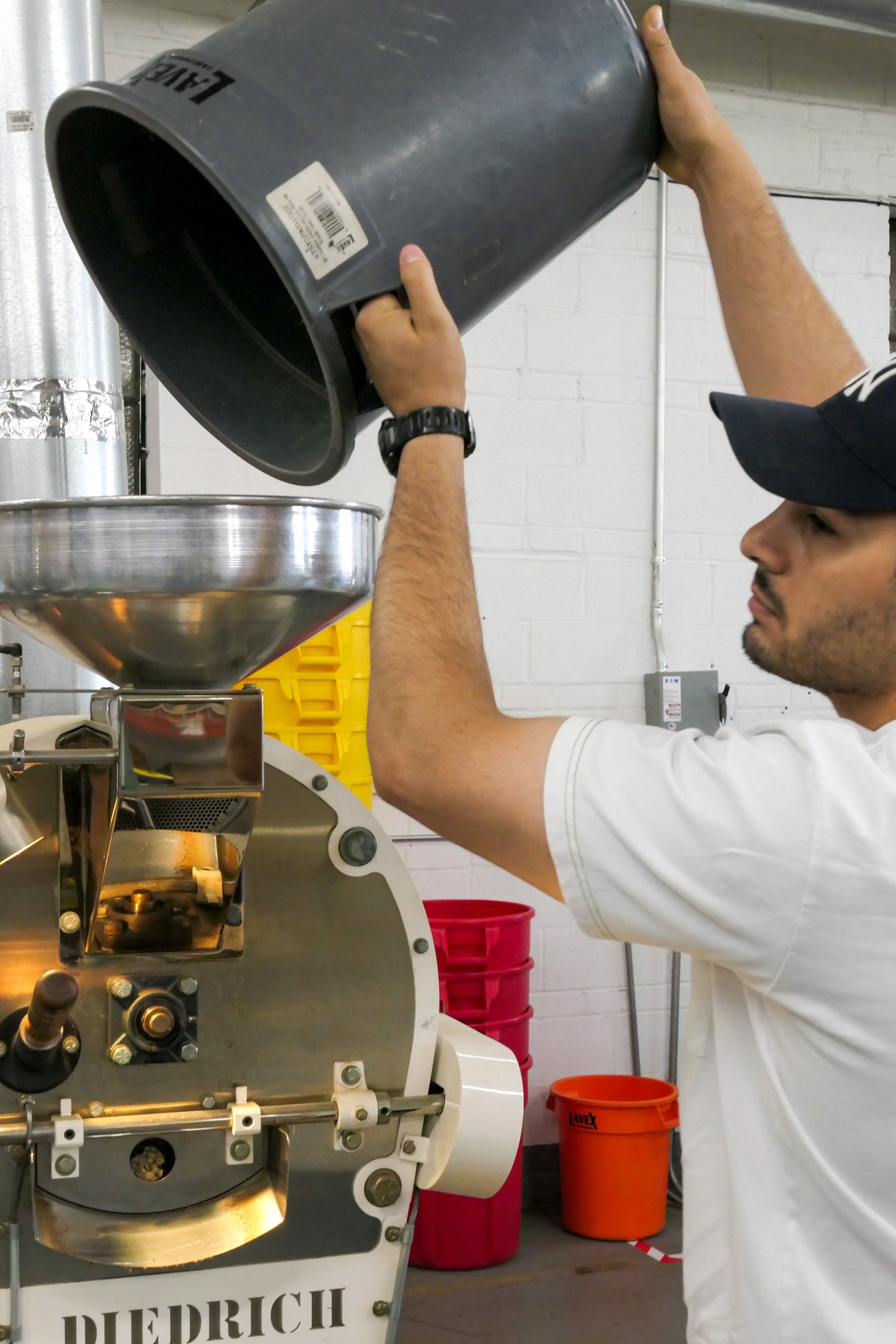 Pouring green beans intoa Diedrich 5kg roasting machine